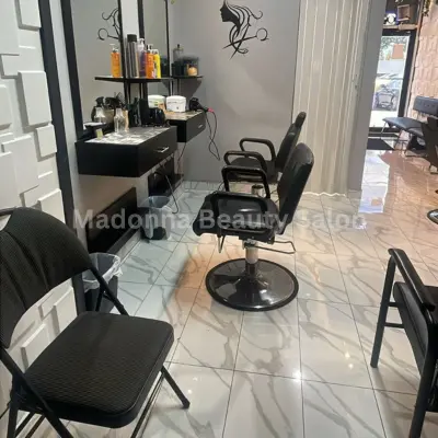 Hygiene and Safety - Madonna Beauty Salon Madonna Beauty Salon interior featuring several styling chairs arranged in front of a large mirror.